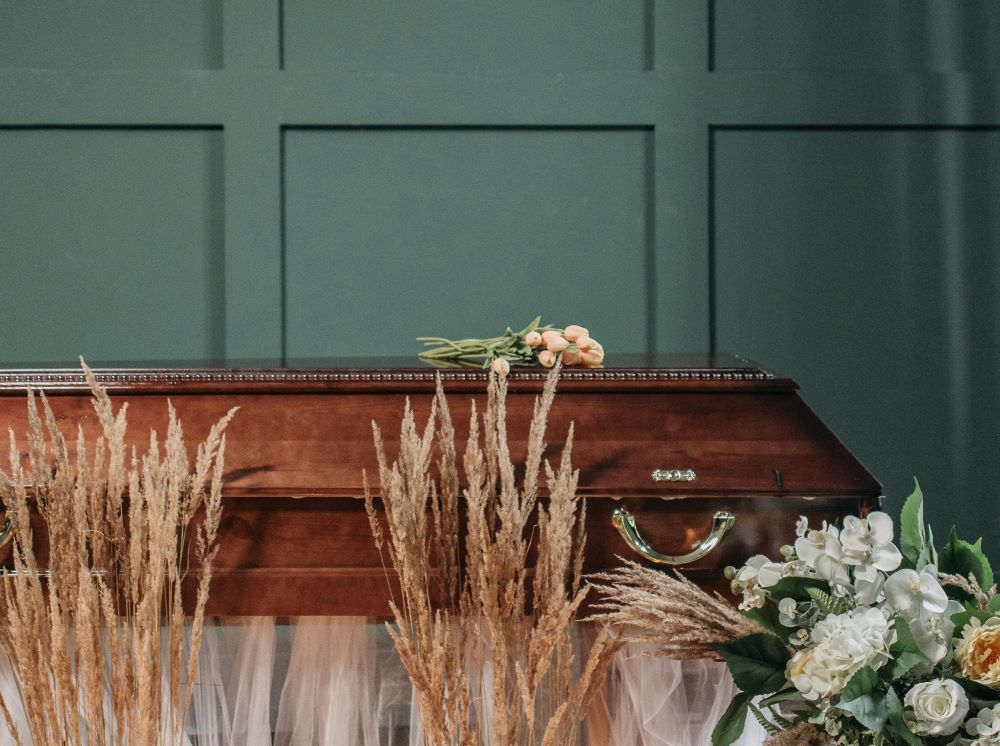 funeral casket with green background